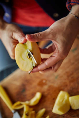 Cropped view of woman chopping appleの写真素材
