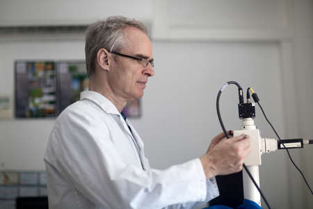 Male meteorologist using equipment in weather station laboratory