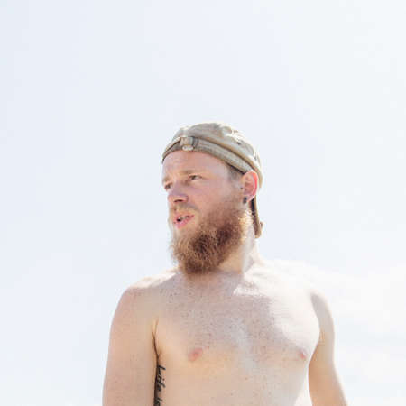 Bearded bare chested man looking awayの写真素材