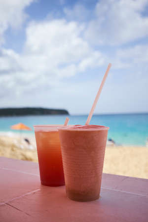 Cups of cold drink, beach in backgroundの写真素材