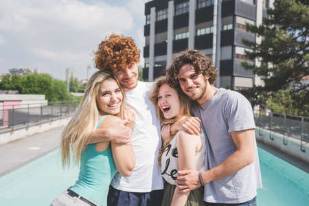 Couples hugging, pool in backgroundの写真素材