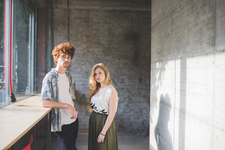 Co-workers beside bar counter by windowの写真素材
