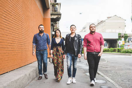 Group of friends walking on sidewalk