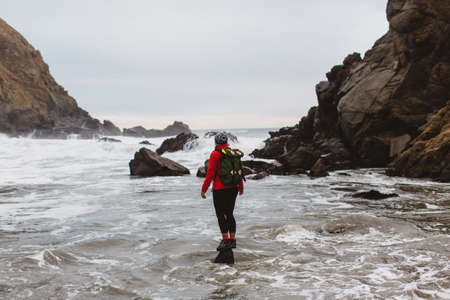 Hiker enjoying view on beach, Big Sur, California, USA