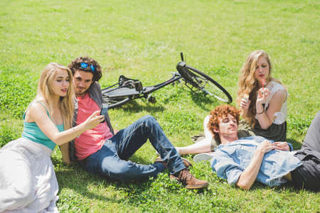 Couples relaxing in park