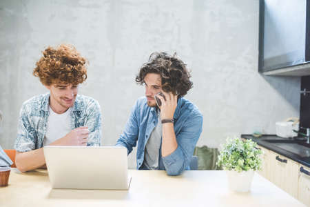Co-workers working on laptop in office