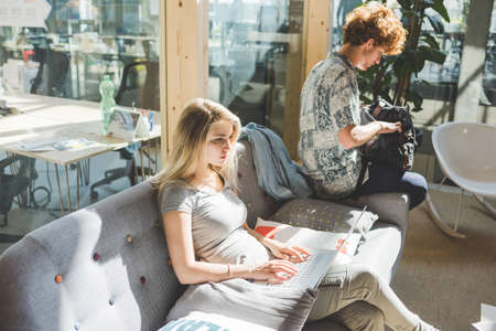Co-workers working in open plan office