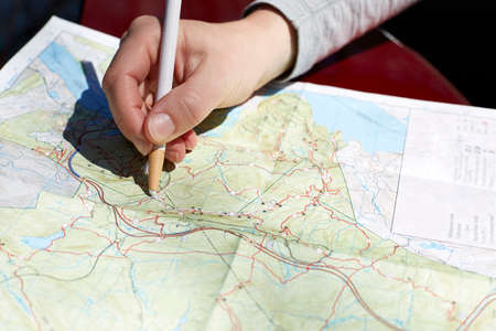 Woman's hand on folding map of Harriman and Bear State Parks, New York State, USAの写真素材