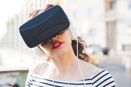 Woman wearing virtual reality and headphonesの写真素材
