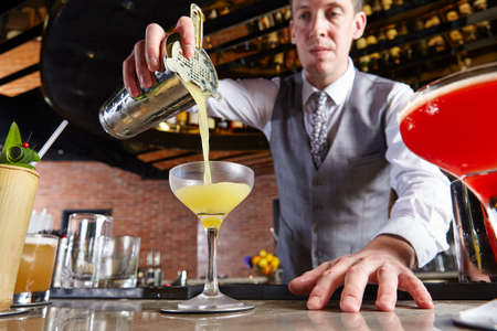 Bartender pouring cocktailの写真素材