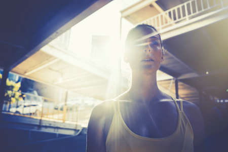 Young woman wearing sports vest in urban environmentの写真素材