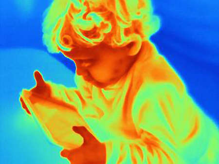 Thermal image of male toddler looking at digital tablet