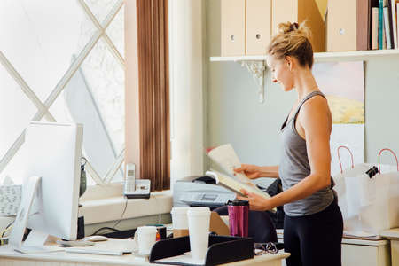 Woman in office holding paperwork