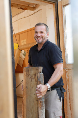 Man carrying timberの写真素材