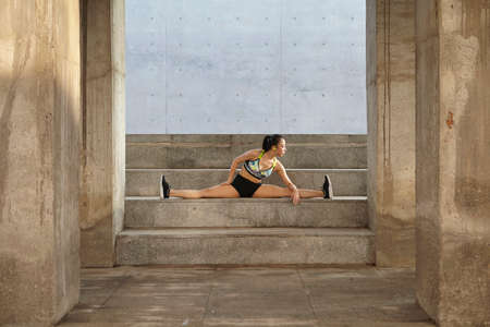Woman doing splits on steps