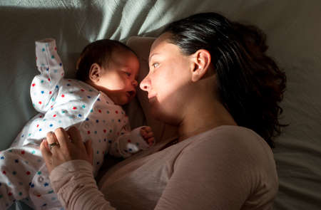 Mother and son resting in bedの写真素材