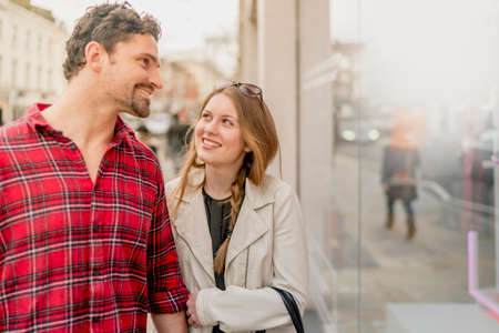 Young couple window shopping on Kings Road, London, UKの写真素材