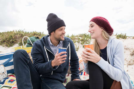 Young couple picnicking on beach, Western Cape, South Africa