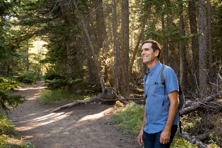 Happy senior male hiker in forest, Canmore, Alberta, Canadaの写真素材