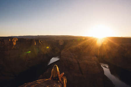 Woman relaxing and enjoying view, Horseshoe Bend, Page, Arizona, USAの写真素材