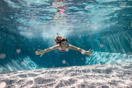 Girl swimming in poolの写真素材