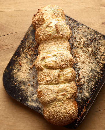 Overhead view of fresh Greek sesame bread on baking tray