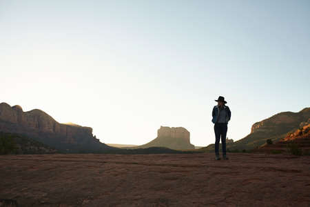 Woman standing in desert, looking at view, Sedona, Arizona, USA