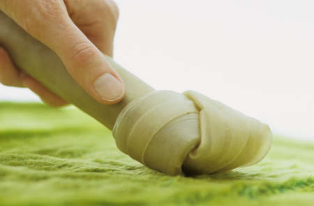 Close-up hand with dog chewの写真素材