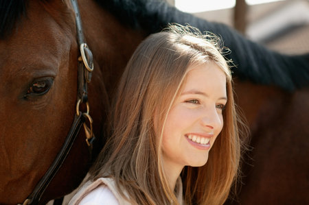 Young woman and her horseの写真素材