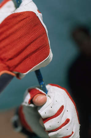 Close-up of gloved hands holding rope