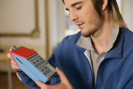 Man holding a model house