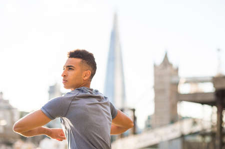 Man stretching, Wapping, London, UK