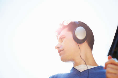 Young man wearing headphones listening to music