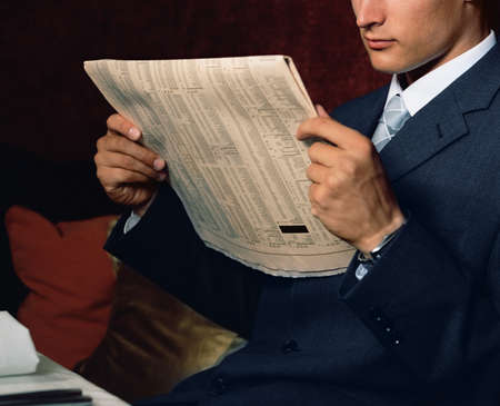 Businessman reading financial paperの写真素材