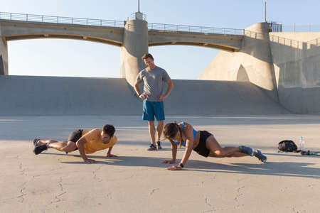 Athlete observing friends workout, Van Nuys, California, USA