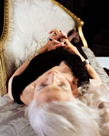 Senior woman sleeping on a chaise longue
