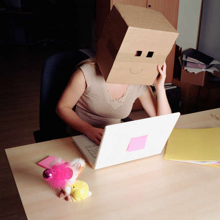 Woman wearing a cardboard boxの写真素材