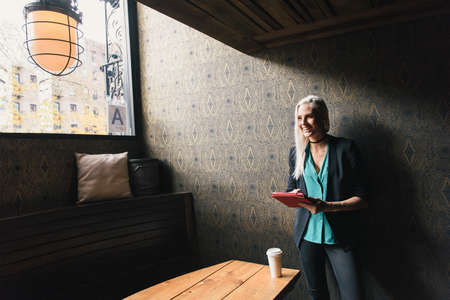 Woman using digital tablet smiling