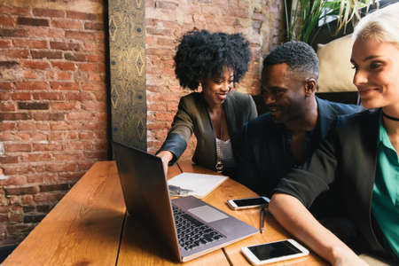 Colleagues in meeting using laptop