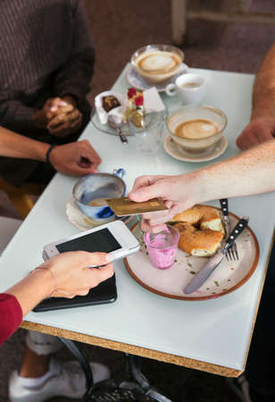 Close-up of man paying with credit card in restaurant