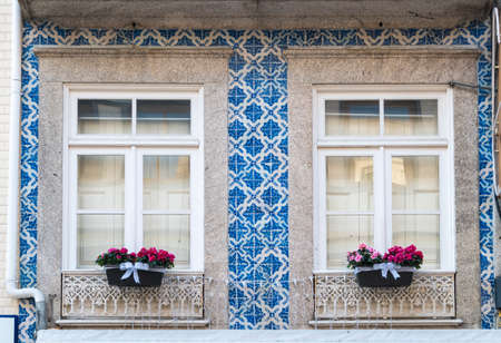 Portugal, Porto, Apartment building with flowers on windows and azulejosの写真素材