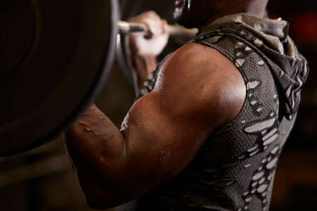 Close-up of man weightlifting in gym