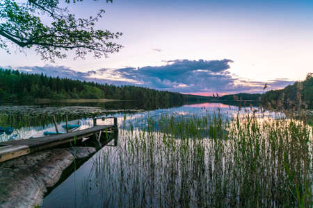 Lake reflecting clouds at sunsetの写真素材