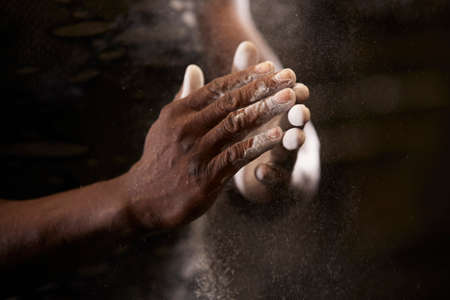 Close-up of mans hands with chalk in gymの写真素材