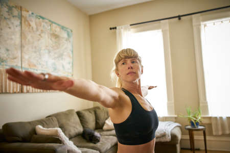 Mature woman practicing yoga at home