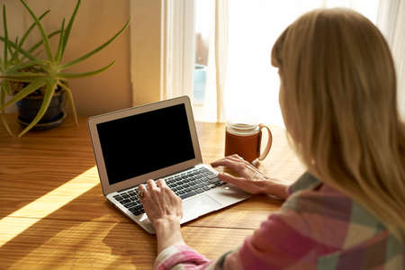 Woman using laptop at home