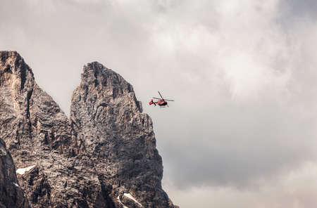 Helicopter flying above mountain peak, Corvara, Alta Badia South Tyrol, Italyのeditorial素材