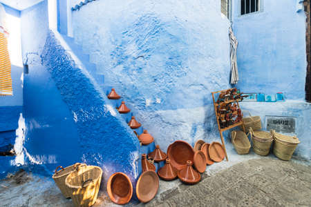 Morocco, Chefchaouen, Ceramic tajines and baskets for sale at blue buildingのeditorial素材