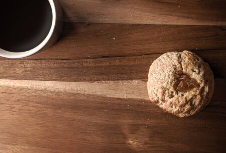 Coffee and a cake on a wooden table with the morning light, healthy breakfast, concept relaxing...