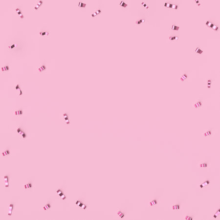 Spurs on a trendy pastel pink background. Festive background with confetti. fashion concept.の写真素材